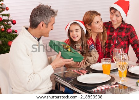 Christmas concept. Happy family at lunch with tree on background.