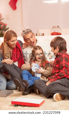Happy family of four people celebrating Christmas at home. Holiday concept.