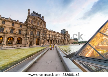 PARIS - JUNE 15 : Louvre museum at twilight in summer on June 15, 2014. Louvre museum is one of the world\'s largest museums with more than 8 million visitors each year