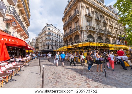 PARIS - MAY 21, 2014: Tourists walk in Quartier Latin. More than 30 million people visit Paris annually.