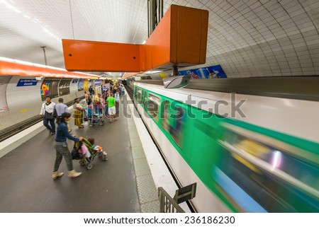 PARIS - MAY 23, 2014: Paris Metro station with fast moving train in Paris, France. Paris Metro is the 2nd largest underground system worldwide by number of stations (300)