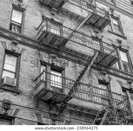 Building with green ladders for fire escape, Mott Street New York.