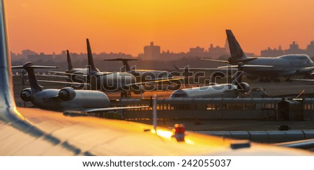 Airplanes on the runway ready to takeoff. Airport sunset.