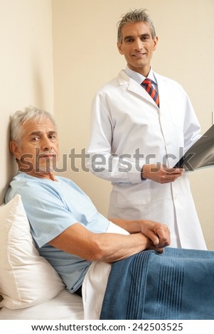 Doctor explaining medical test to male patient in 60s. Happy scan test.