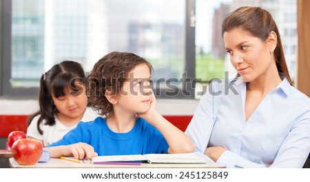 Teacher looking at kid with interrogative look.