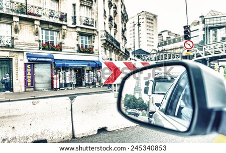 Leaving Paris by car. Eiffel Tower in the rear mirror.