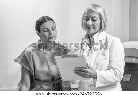 Expert female doctor explaing medical test to female patient in 40s.