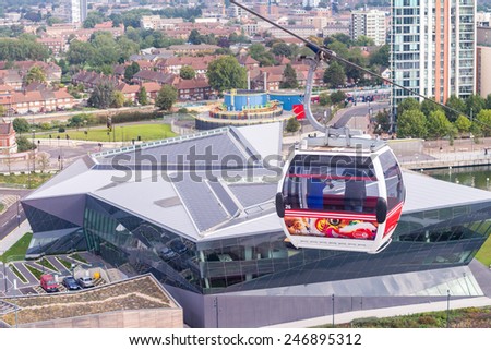 LONDON - AUG 24: Visitors travel on the Emirates cable car. The service is London first urban cable car which crosses the Thames from Excel centre to the O2 on August 24, 2013 in London UK.