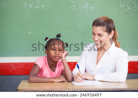 Happy female teacher comforting sad afroamerican schoolgirl.