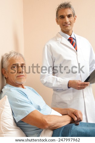 Doctor explaining medical test to male patient in 60s. Happy scan test.