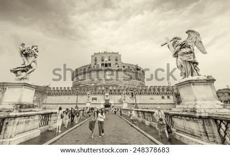 ROME - MAY 15, 2014: Tourists walk near Saint Angel Castle. More than 15 million people visit the city every year.