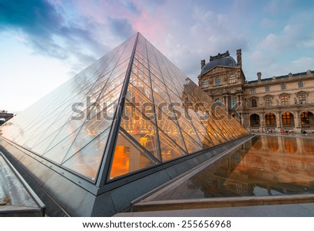 PARIS - JUNE 15 : Louvre museum at twilight in summer on June 15, 2014. Louvre museum is one of the world\'s largest museums with more than 8 million visitors each year