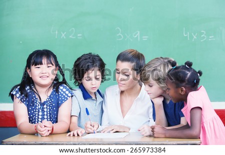 Multi ethnic classroom with teacher explaining mathematics lesson.