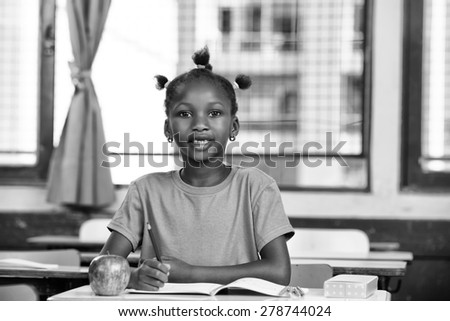 Afro american girl at school desk.