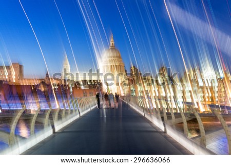 Blurred image of people moving along Millennium Bridge, London.