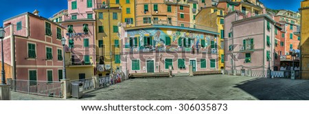 RIOMAGGIORE, ITALY - SEPTEMBER 21, 2014: Colorful city buildings on a sunny day. Riomaggiore is part of Five Lands, one of the major italian tourist destination.