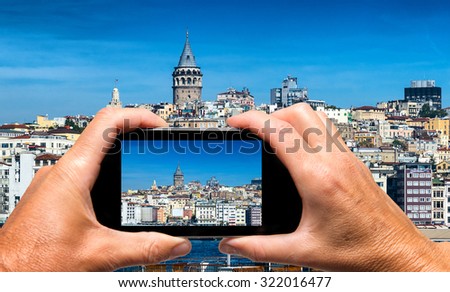 Man and woman hand capturing Beyoglu skyline skyline with smartphone