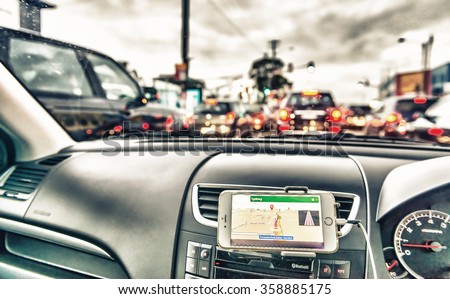 GPS device in a car, satellite navigation system along city streets.