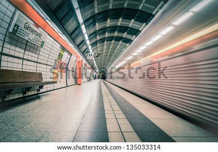 HAMBURG, GERMANY - SEPT. 16: a train passes by a completely empty subway station in the business district on September 16, 2012 in Hamburg. Sundays, closed offices make this station empty.