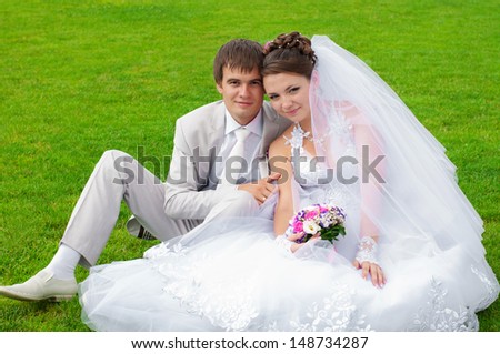 Young and beautiful bride and groom smiling at each other