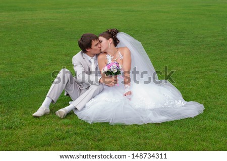Young and beautiful bride and groom smiling at each other