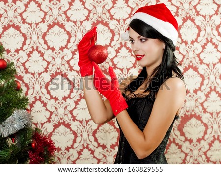 Beautiful girl near a christmas tree with gifts in hand