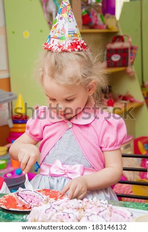 little girl eating cake on her birthday party