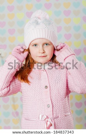 little girl in a pink hat and a sweater