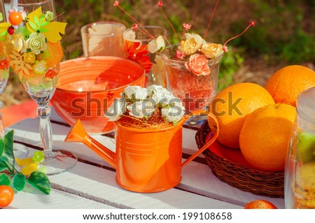 Orange picnic with oranges flowers and glasses of summer