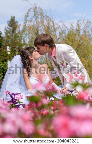 Young and beautiful bride and groom kissing