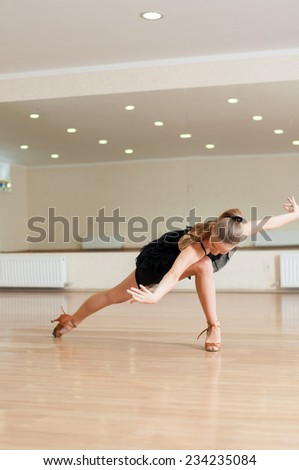 Young girl dancer doing exercises in a dance class