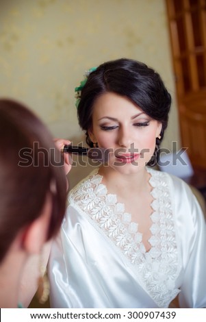 bride makeup is applied in the morning