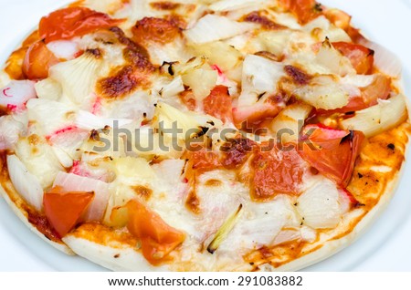 Pizza on white dish and wood table