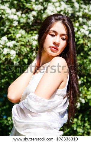 Close-up portrait of beautiful asian young woman resting on nature