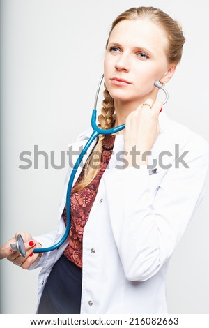 Portrait of an elegant doctor woman in medical gown on white background isolated