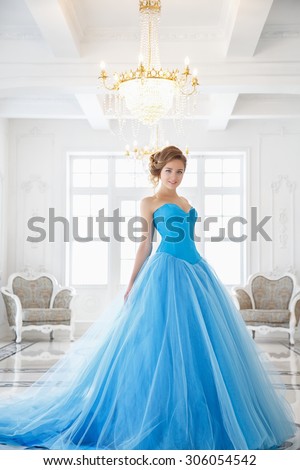 Beautiful bride in gorgeous blue dress Cinderella style in a morning