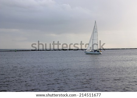 Light from heaven shining in cloudy weather on a sailboat