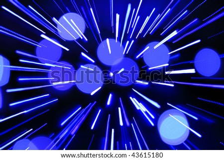 abstract rays scattering from center and round spots background in blue colors