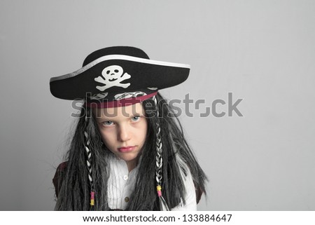 little boy in a costume pirate Jack Sparrow on a light background