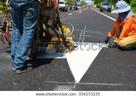 Thermoplastic spray marking machine during road construction work