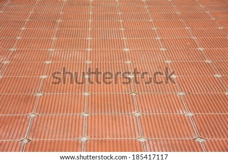 beautiful patio of square red brick clay tile floor with rough pattern style