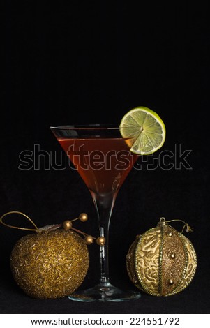 chilled cocktail glass with a cocktail and christmas decorations.