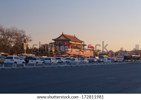 BEIJING, CHINA - DEC 5: Tienanmen Gate (The Gate of Heavenly Peace) with passing traffics at sunrise on Dec 5, 2013.  It is a famous monument in Beijing