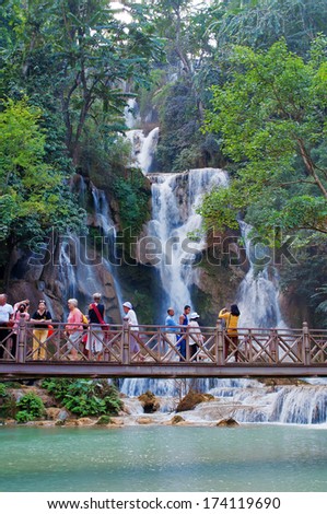 LUANG PRABANG, LAOS - DEC 9: The Kuang Si Falls on Dec 9, 2012, in Luang Prabang, Laos. The falls begin in shallow pools atop a steep hillside. These lead to the main fall with a 60 metres cascade.