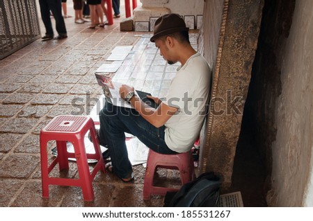 MALACCA, MALAYSIA - DEC 19, 2013: Artist in St. Paul\'s Church at Malacca. Malacca City is the capital city of the Malaysian state of Malacca. It was listed as UNESCO World Heritage Site on 7 July 2008