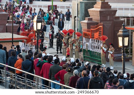 AMRITSAR, INDIA, DEC - 6, 2014: The India-Pakistan Wagah Border Closing Ceremony. The flag ceremony happens at the border gate, two hours before sunset each day.