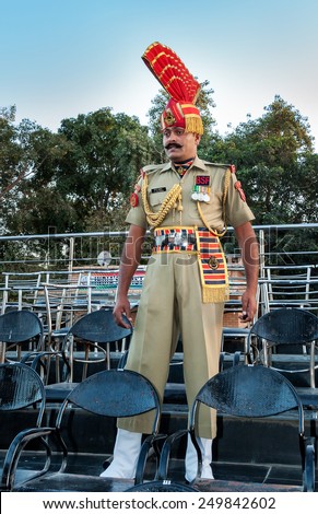 AMRITSAR, INDIA, DEC - 6, 2014: Unidentified Indian guard in the India-Pakistan Wagah Border Closing Ceremony. The flag ceremony happens at the border gate, two hours before sunset each day.