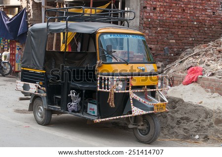 AMRITSAR, INDIA, DEC - 7, 2014:  Auto rickshaw or tuk-tuk on the street. Auto rickshaws are a common means of public transportation in India