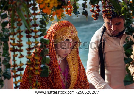 RISHIKESH, INDIA - DEC 12, 2014: Unidentified bride in traditional Indian wedding at temple near River Ganga