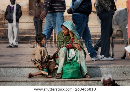 ORCHHA, INDIA - DEC 19, 2015: Unidentified Indian mother and son talking on the street at the temple. Orchha is a town in Madhya Pradesh state